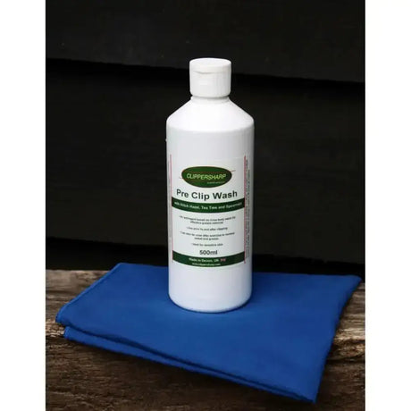 White plastic bottle of clippersharp pre clip wash with green label and white cap for effective grease removal 500ml