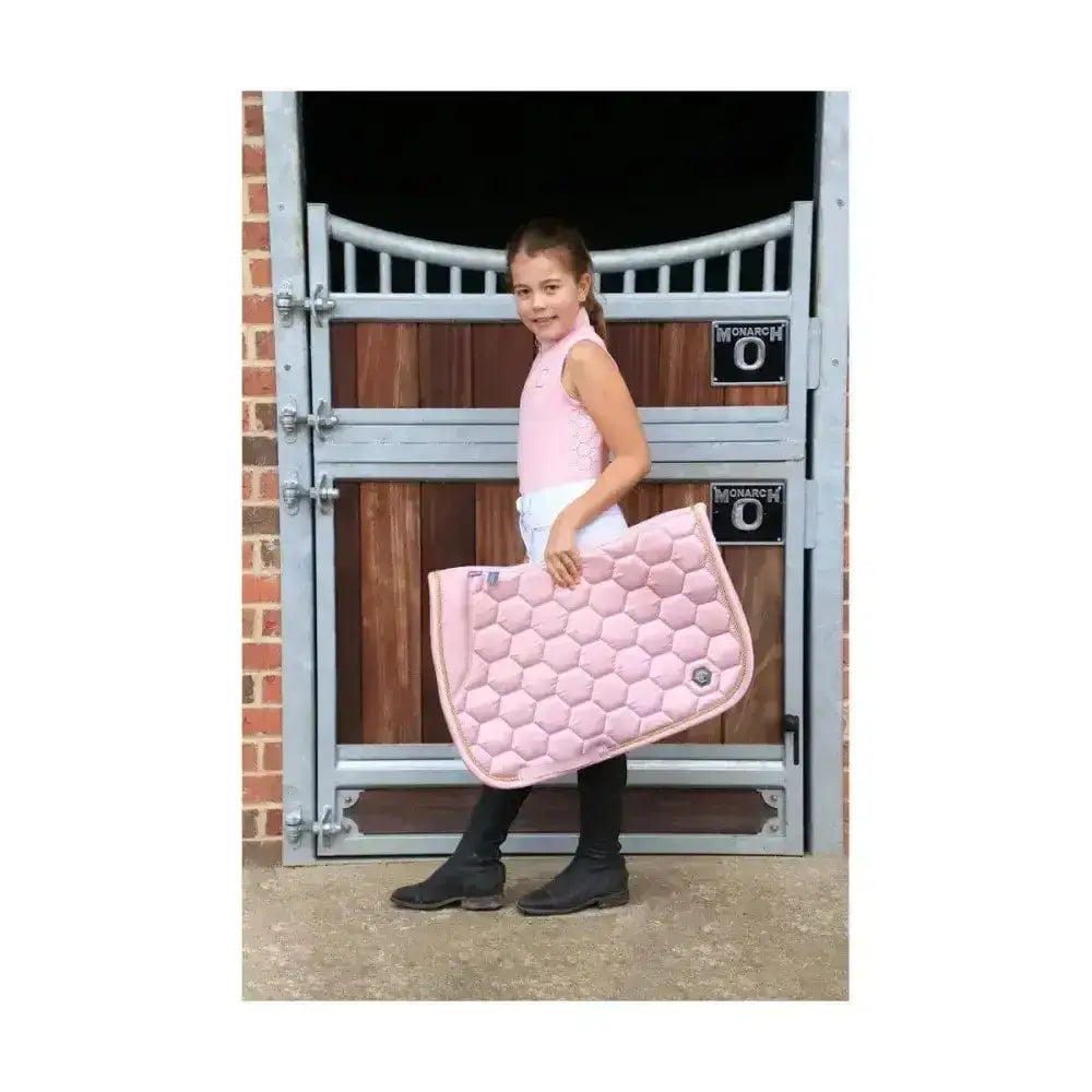 Pink quilted horse saddle pad with hexagonal pattern shown with coldstream cranshaws sleeveless base layer