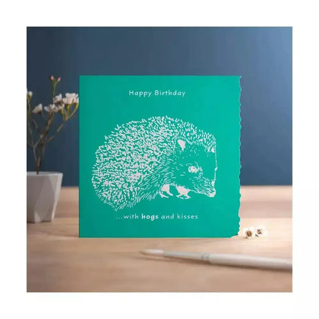 Teal colour block happy birthday card with white laser-cut hedgehog and happy birthday hogs and kisses text