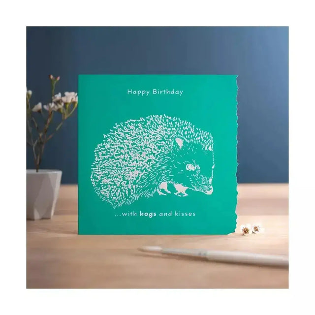 Teal colour block happy birthday card with white laser-cut hedgehog and happy birthday hogs and kisses text