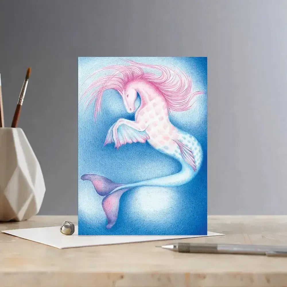 A whimsical colour block pony card merhorse featuring a pink pastel mermaid unicorn on a dreamy blue background