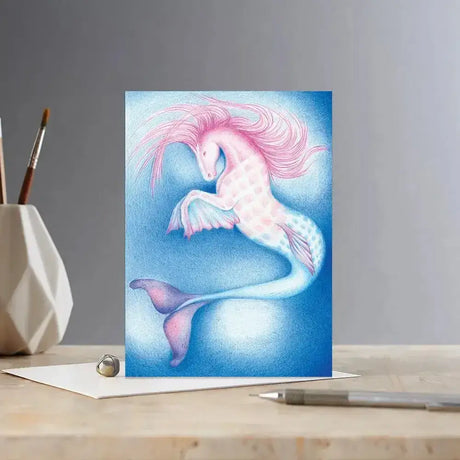 A whimsical colour block pony card merhorse featuring a pink pastel mermaid unicorn on a dreamy blue background