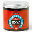 A cylindrical container of carr and day and martin cornucrescine original hoof ointment with vibrant orange label and coronet band text
