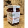 A glass jar of country markets damson jam with a white lid filled with dark red markets damson jam