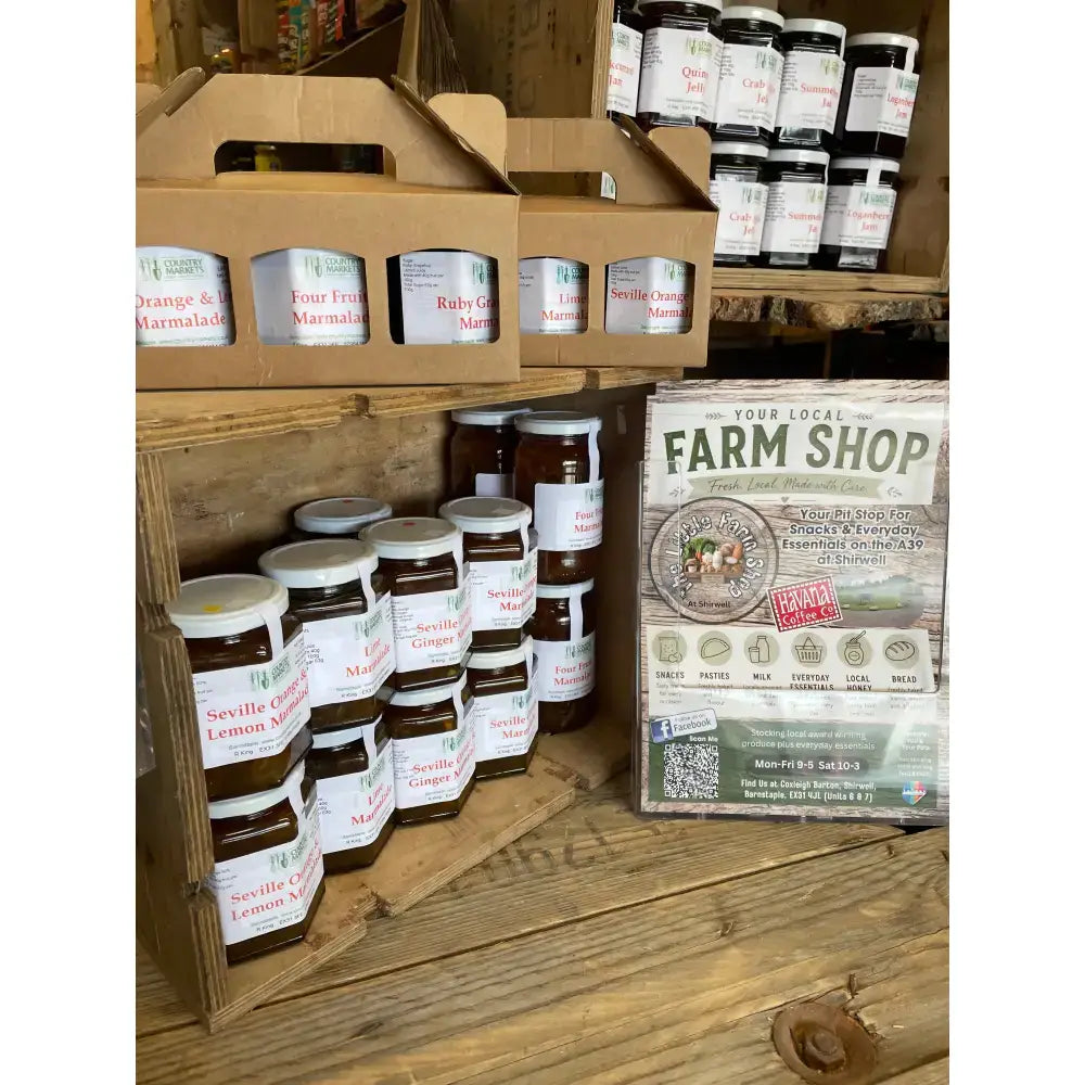 Stacks of glass jars filled with amber mixed preserves gift sealed with white lids from country markets mixed gift pack
