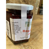 A glass jar of country markets raspberry jam with a white lid and red label perfect for breakfast spreads