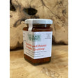 A glass jar of country markets roast pepper chutney with a white lid showing vibrant red-orange tomato condiment