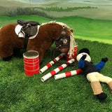 Brown plush crafty ponies body protector horse with black saddle and bridle lying on green grass shows ponies body protector helps