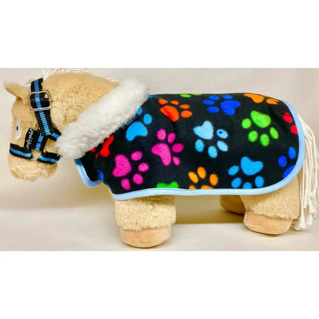 A plush toy horse wearing a black crafty ponies fleece neck show rug with rainbow paw prints and white faux fur trim