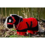 A plush black pony with white mane and tail wearing a red and black riding coat in the crafty ponies fleece rug set