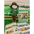 A plush doll from crafty ponies gary family wearing a green long-sleeved shirt brown pants and matching brown cap