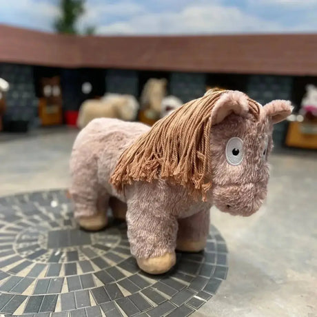 A soft pink crafty ponies soft toy pony roan with tan rope mane and big white eyes perfect for cuddling