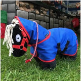 Blue and red crafty ponies turnout rug with white braided mane and black plush head featuring oversized eye