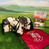 A plush black and white spotted pony with brown leather tack from the crafty ponies western tack starter set