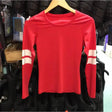 Red long-sleeved cross country top with white strips on sleeves hanging on wooden hanger perfect for equestrian use