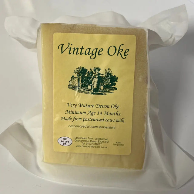 A block of curworthy cheese vintage oak mature devon cheese wrapped in clear plastic with yellow label and black text