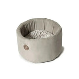 A cosy cat bed by danish design arctic with a soft gray plush exterior and textured white interior lining