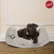 Gray plush dog bed with soft textured exterior and white lining from danish design bobble deluxe slumber bed