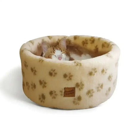 Cream-colored danish design cat cosy cat bed with soft rounded plush and subtle brown paw print pattern for ultimate luxury bed