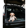 A light-colored labrador resting on a dark green danish design county duvet dog bed in an suv trunk practical solution