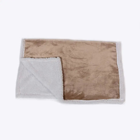 A cozy tan and white sherpa fur blanket from danish design essentials with soft plush texture on both sides