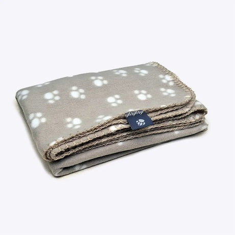 A soft gray danish design essentials polar fleece blanket with white paw prints and a neat stitched edge