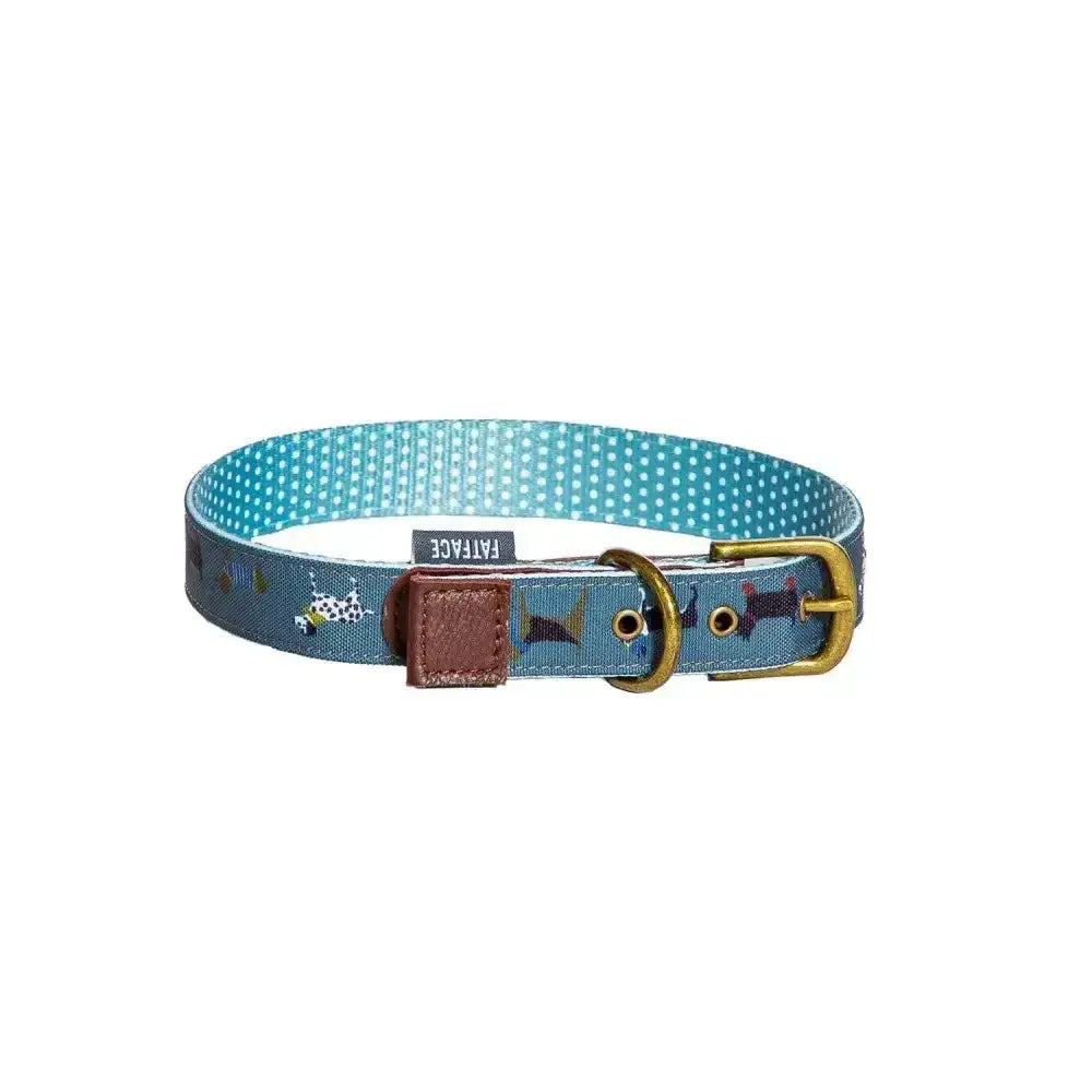 A teal danish design fatface marching dogs collar with polka dots fish prints brass buckle and brown leather tab