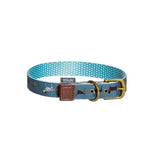 A teal danish design fatface marching dogs collar with polka dots fish prints brass buckle and brown leather tab