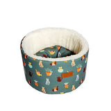 A cozy teal danish design fatface cat cosy bed with plush white interior and fatface mischievous cats pattern