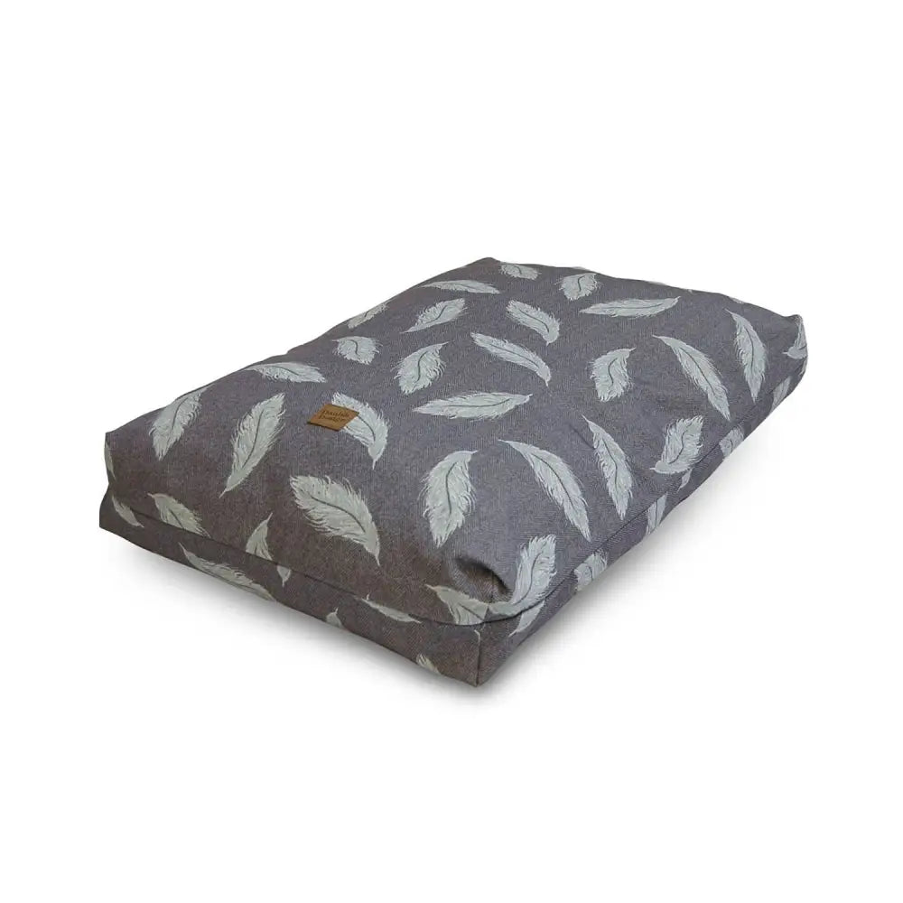 Gray feather-patterned dog bed with soft plush texture and white feathers in danish design feather retreat duvet style