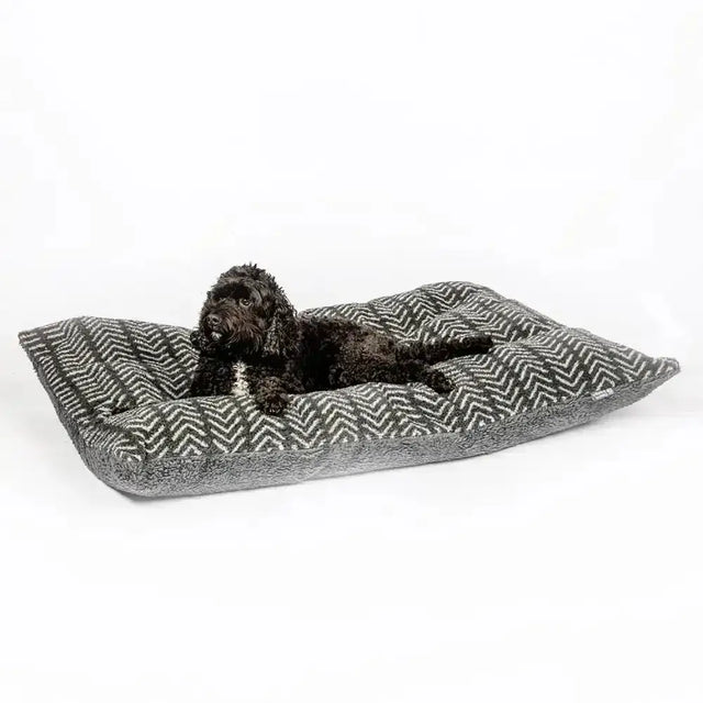 Gray and white herringbone dog bed with plush fabric shown with danish design fleece duvet cover charcoal arrows