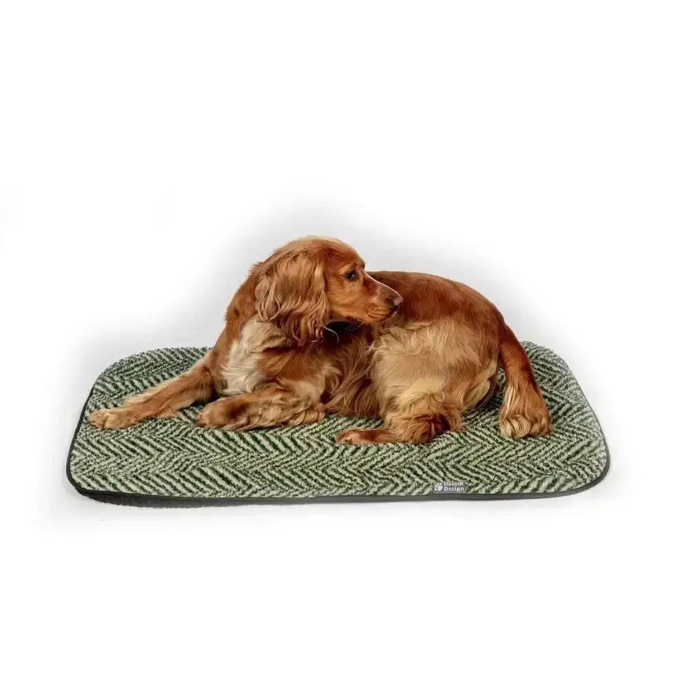 A cozy danish design green herringbone fleece dog bed with soft textured surface perfect for pets