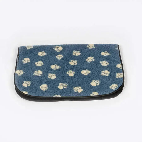 Blue plush dog bed with cream paw print pattern and black trim from danish design harbour paw fleece blanket line