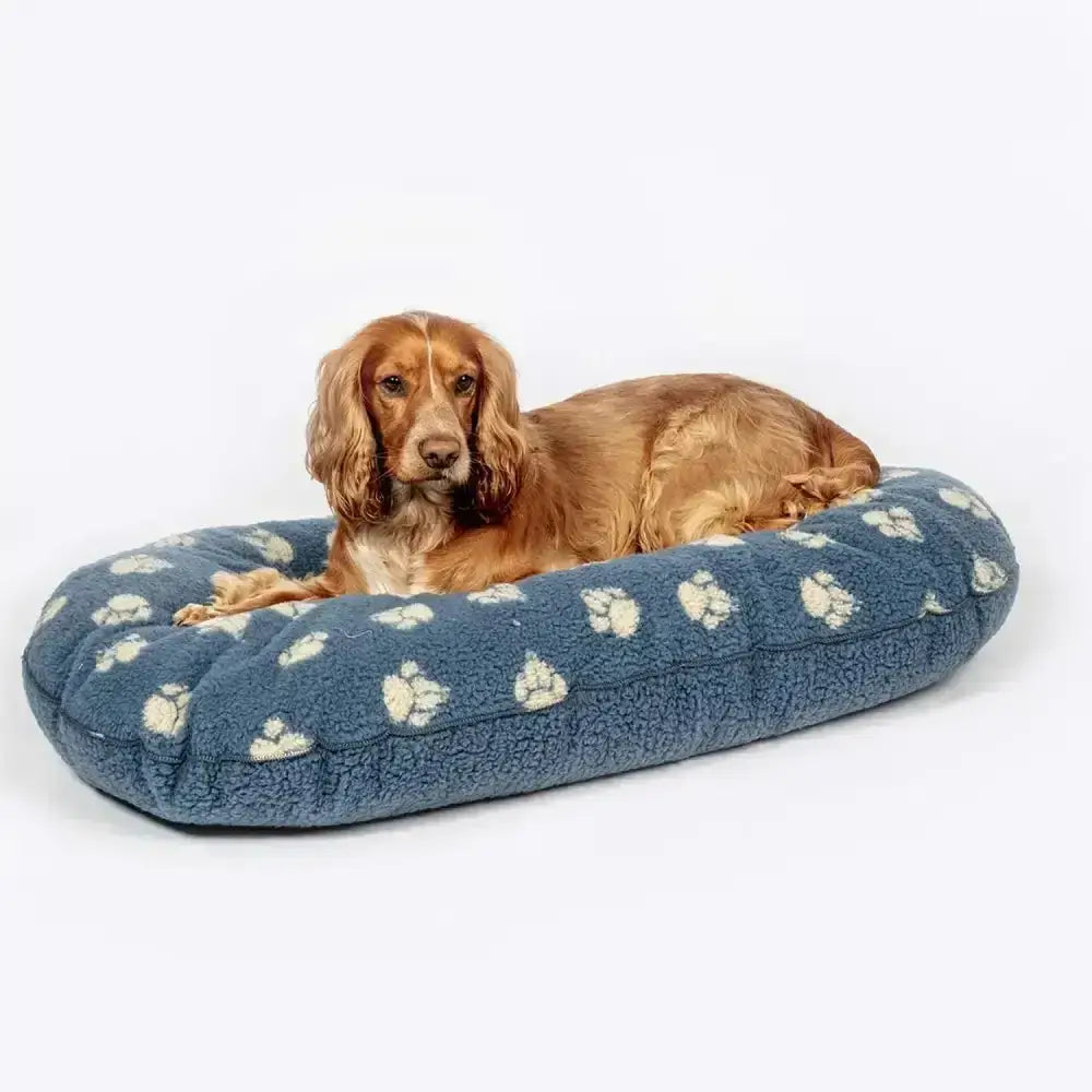 Blue plush dog bed with white paw print pattern featuring danish design harbour paw fleece quilted mattress material