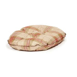 Plaid-patterned circular cushion in beige red and green tones on danish design newton quilted mattress dog bed