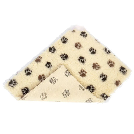 Cream-colored plush danish design pet fleece beige brown blanket with black and brown paw prints and non-slip backing