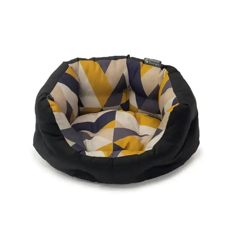 Circular danish design retreat geo tiles eco dog bed with black exterior and mustard navy cream geometric interior pattern