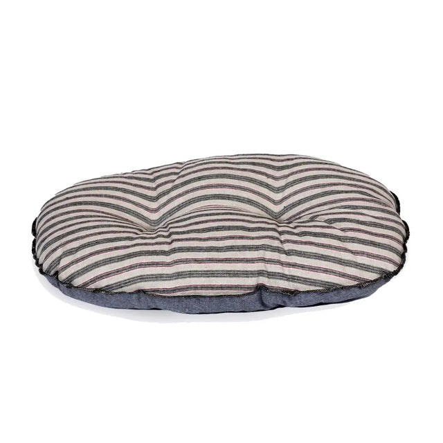 A round cushioned dog bed with soft beige and dark gray rustic stripes quilt fabric top in danish design rustic style