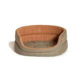 A cozy oval dog bed in beige and orange with danish design tweed fabric in the design tweed slumber style