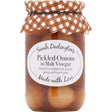 Sarah Darlington’s pickled onions in malt vinegar in a clear jar with a brown and white checkered cloth lid perfect with cheddar cheese