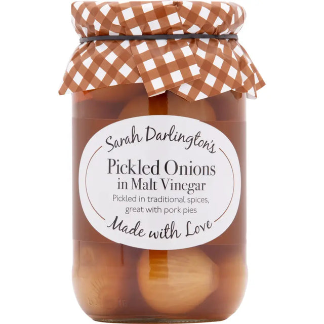 Sarah Darlington’s pickled onions in malt vinegar in a clear jar with a brown and white checkered cloth lid perfect with cheddar cheese