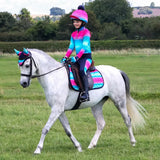 A white horse wearing the dazzling diamond fly veil by little rider with a vibrant pink blue gradient and quality close-knit crochet