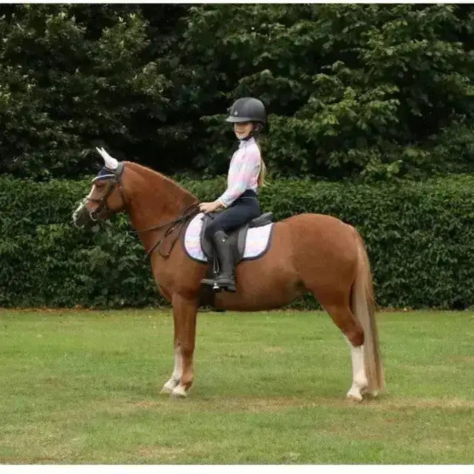 A young rider on a chestnut horse wears a gorgeous dazzling dream saddle pad by little rider in pink and black gear