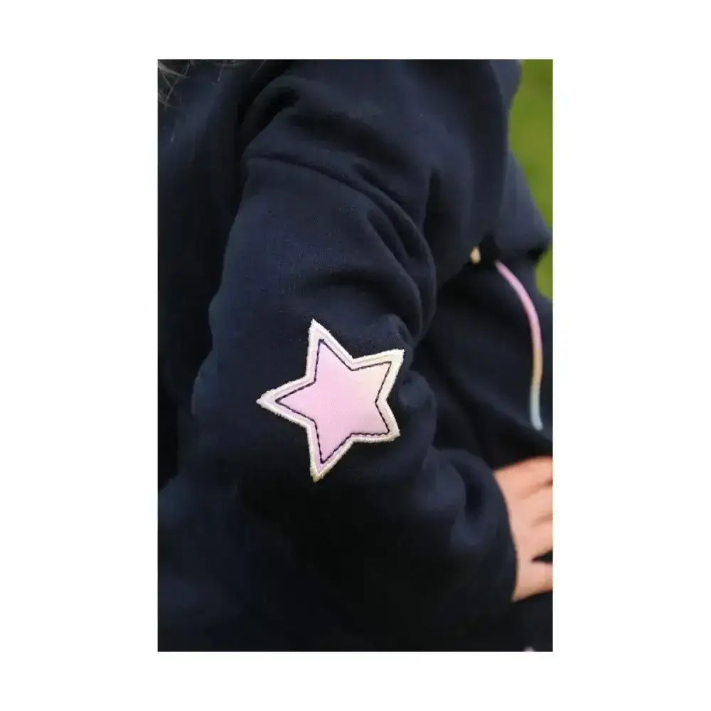 A soft navy blue dazzling dream sweatshirt by little rider with a pink star patch and white stitching on the sleeve