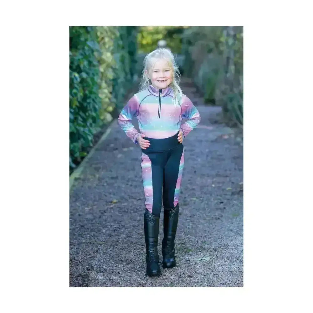 A child wears the dazzling night base funky base layer with rainbow stripes made of flexible fabric by little rider