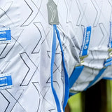 Defencex shield quagga fly rug with white shirt, black geometric pattern, blue straps, and shielding patterned micromesh