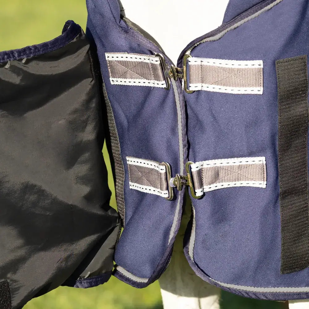 Navy blue defencex shield royal elite fleece rug with gray reflective strips and metal buckles for horse protection
