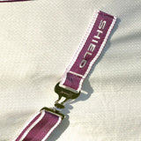 Maroon and white striped fabric strap with silver shield embroidery and metallic buckle on defencex shield sport air cooler rug