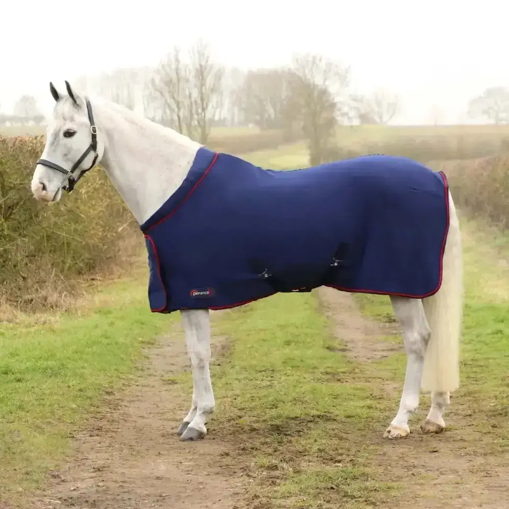 Navy blue defencex system deluxe fleece rug with red trim black buckles and brand logo perfect for horses wardrobe