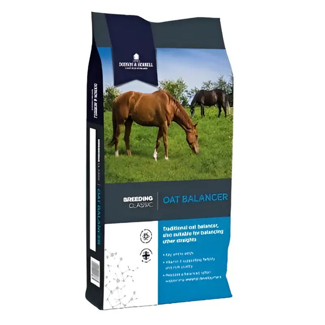 Brown horse grazing on grass with blue and white dodson and scibell horrell oat balancer bag for 100kg bodyweight